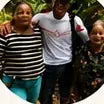 Three members of an Indigenous community standing together.